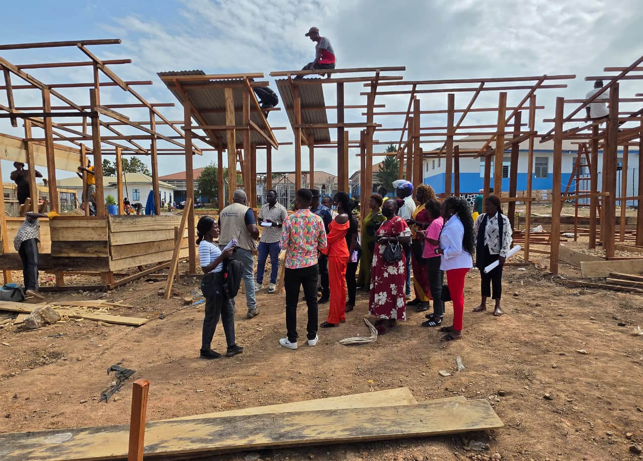 An International Medical Corps staff member leads a group of local leaders and a Ministry of Health journalist on a tour of the ETC as it is constructed in Ituri.