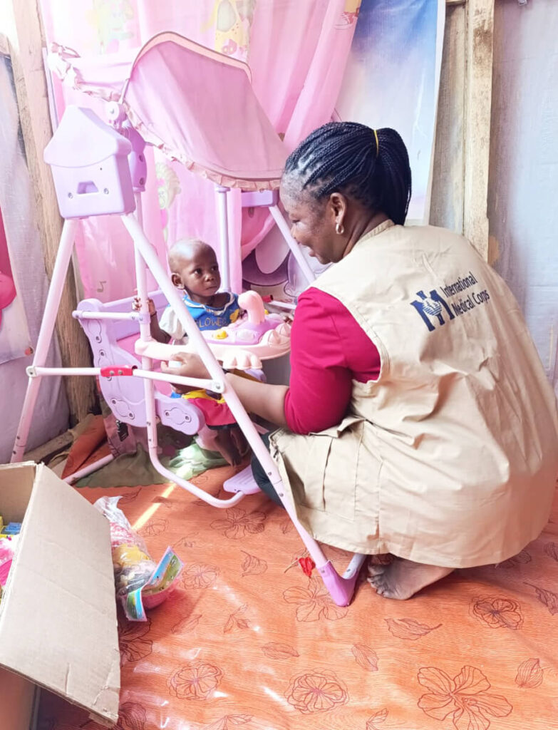 International Medical Corps Nurse Kitiyani Maina interacts with Muhammad at Damboa General Hospital.