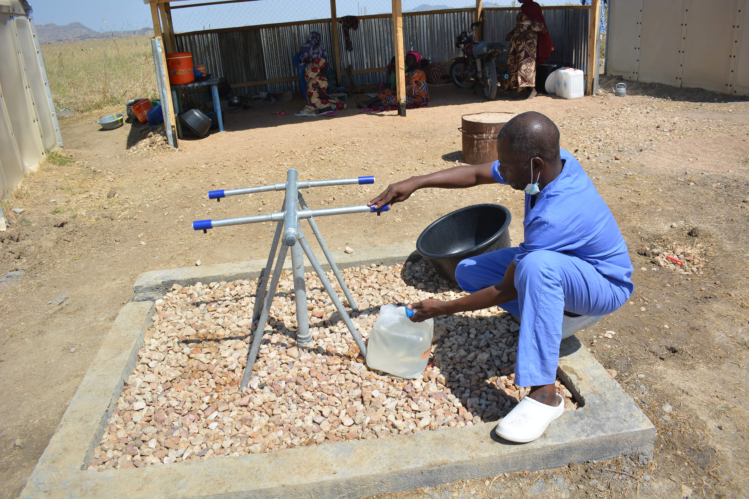 Nurse Aboubakar Ballo, an International Medical Corps staff member in Cameroon, mixes a therapeutic hydration solution for cholera patients at Minawao refugee camp.