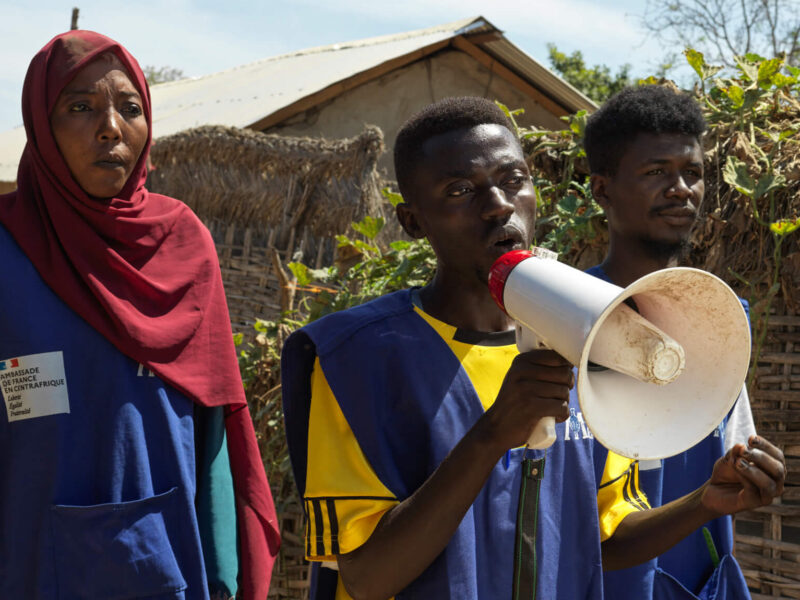 Caption: (Left to right) International Medical Corps staff, Noussaiba Kamiss, Alfati Mahamat and Mahamat conduct community awareness on cholera at Korsi refugee camp, Birao, CAR.