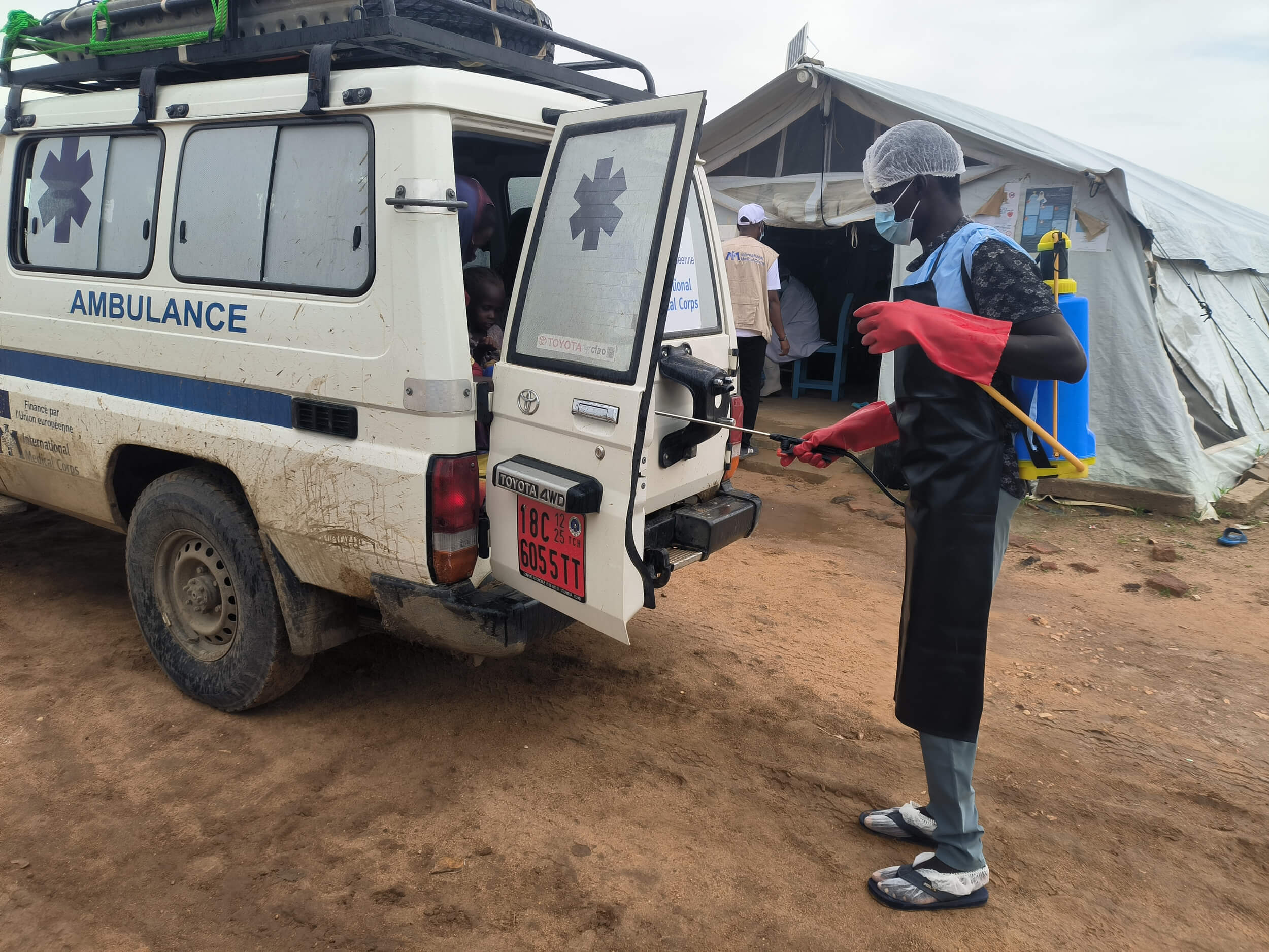 A hygienist in Dougui, Chad, disinfects an ambulance that transported a cholera patient.
