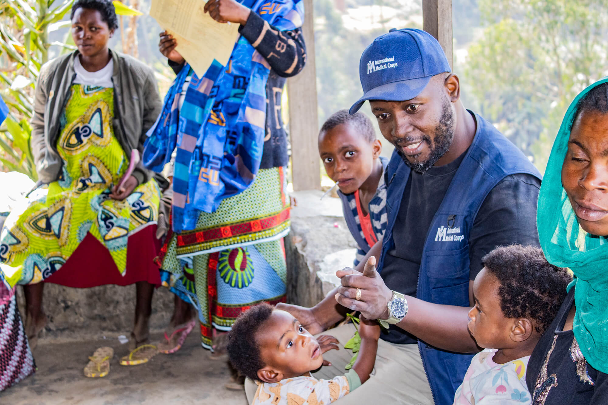 An International Medical Corps staff member interacts with children from the local community.