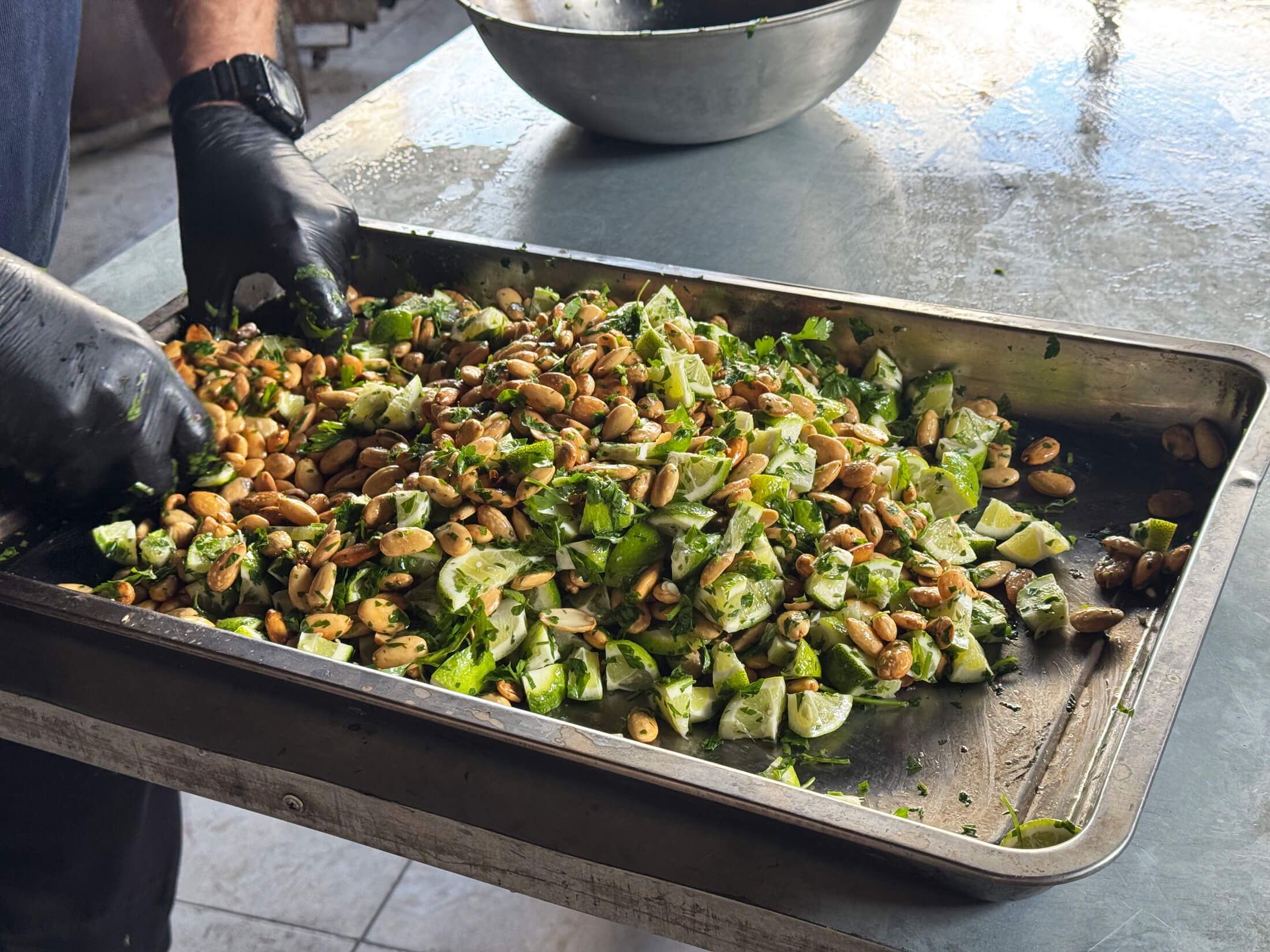 A chef mixes qidra rasht, a Palestinian dish made of nuts and lemon.