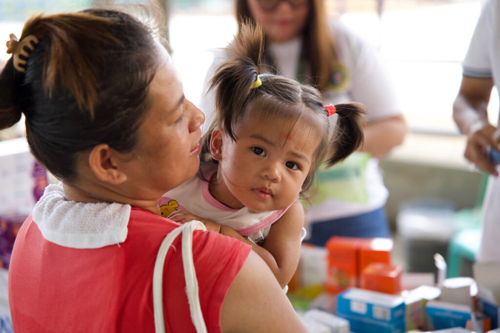 A woman and her daughter wait to be seen by our MMT in Hagonoy.