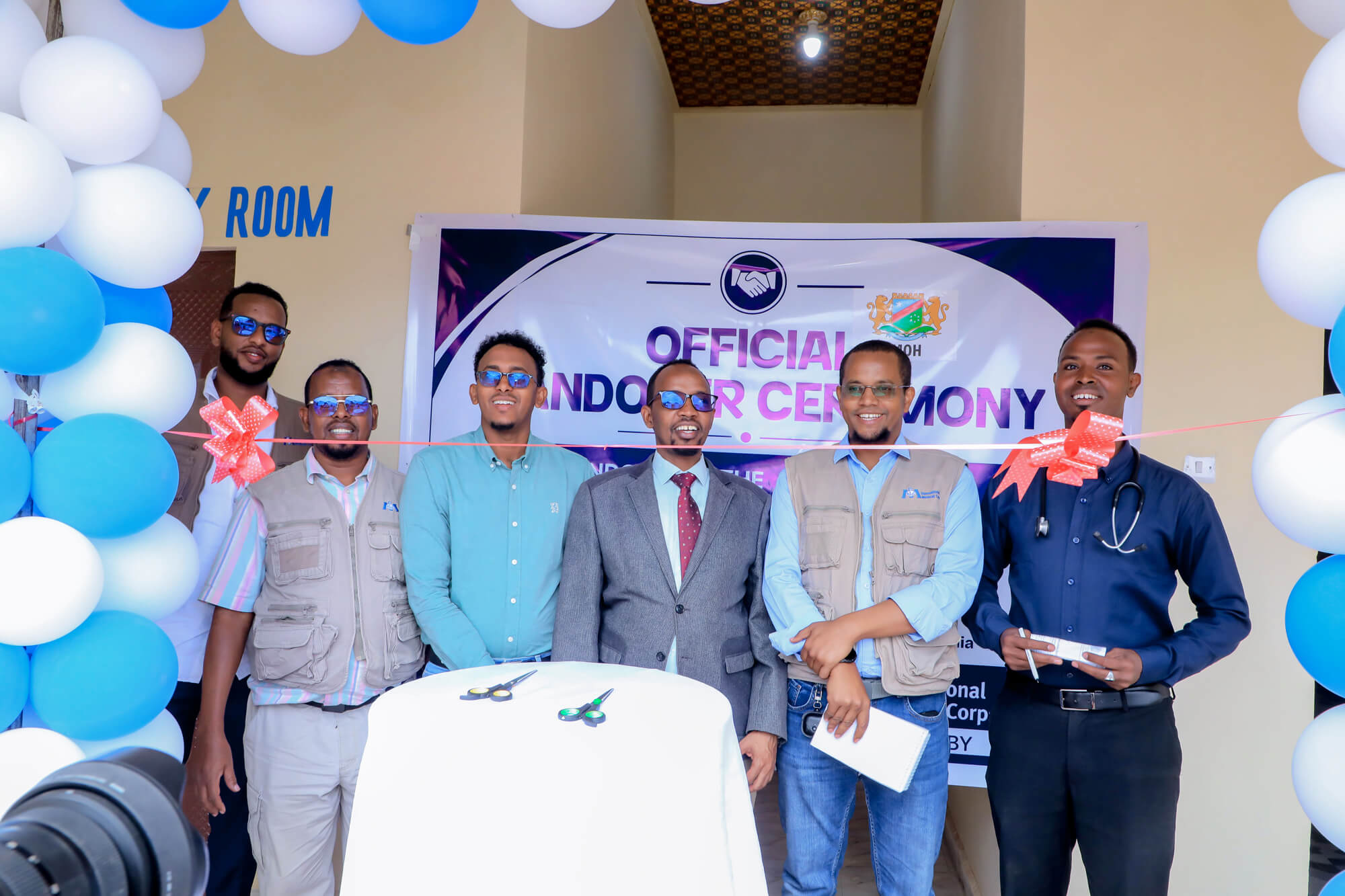 International Medical Corps staff members and Southwest State officials stand in front of the new maternity unit at Suuqa Xoolaha Health Center during the handover ceremony in July.