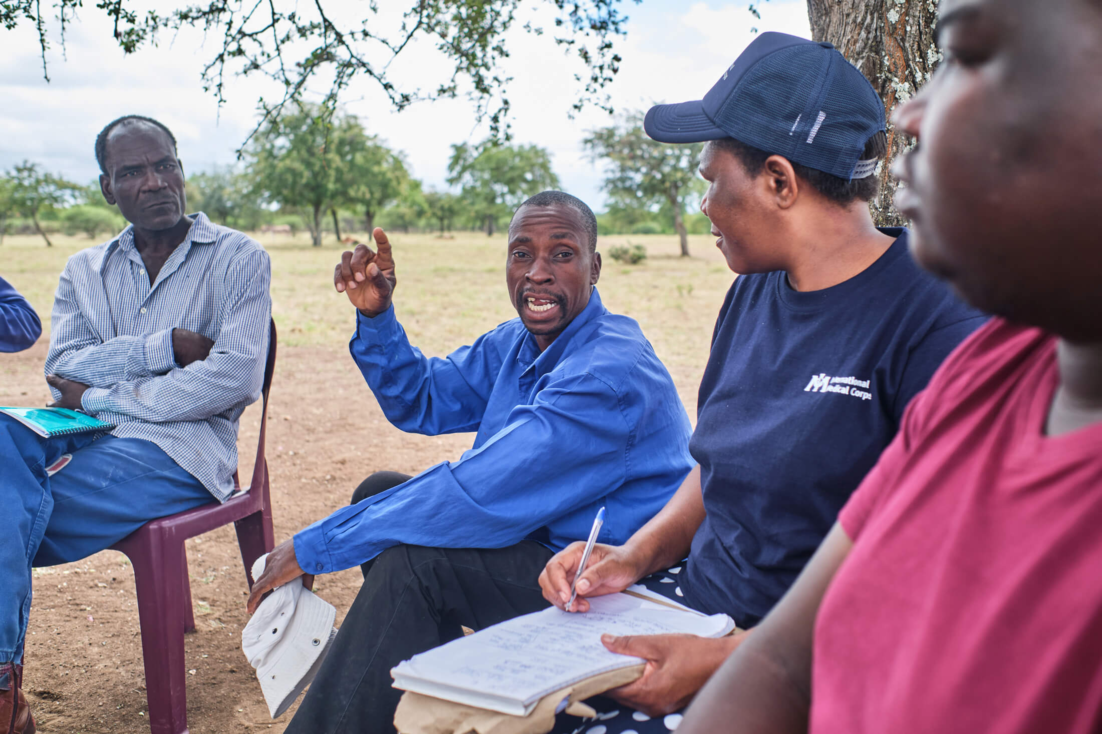 To ensure the long-term resilience of WASH interventions, International Medical Corps trains local community members to take care of boreholes and irrigation systems. Here, a local waterpoint committee meets with a staff member to discuss the village’s water usage.