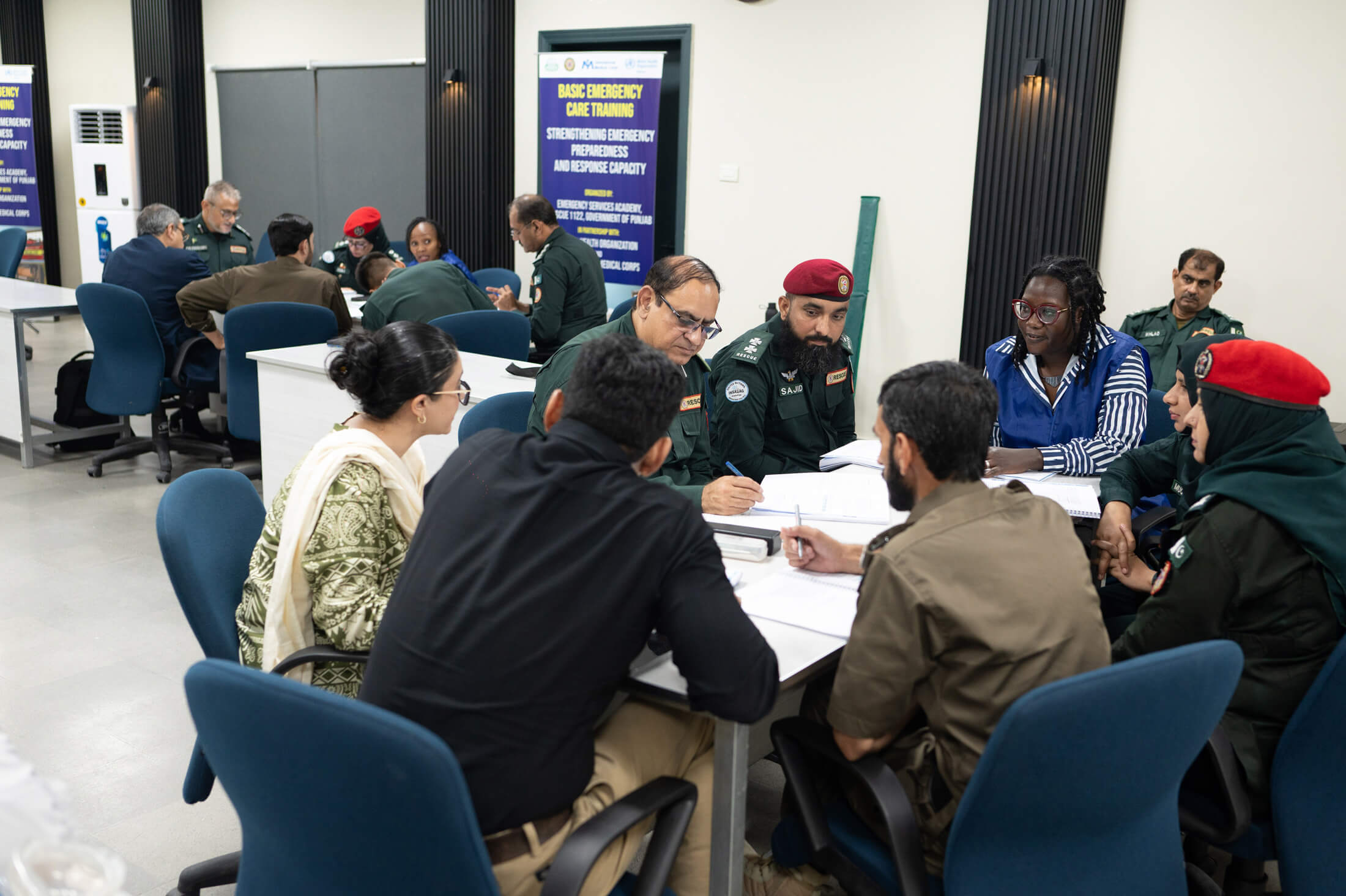 Dr. Mehek Yousafzai (left), Health Manager with International Medical Corps in Pakistan, co-leads a small-group discussion with Dr. Trufosa Mochache on the ABCDE approach.