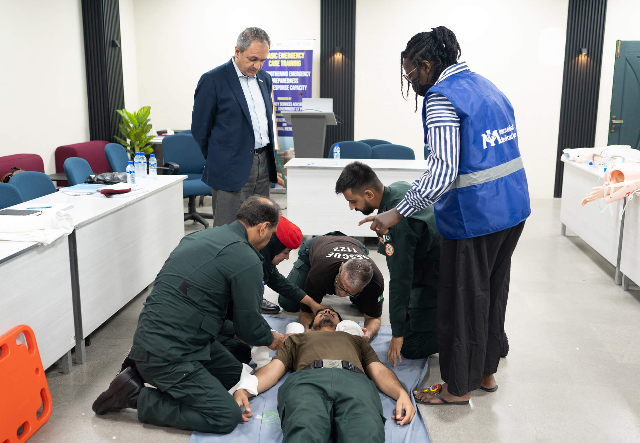 Dr. Trufosa Mochache oversees a BEC demonstration with students on cervical spine immobilisation.