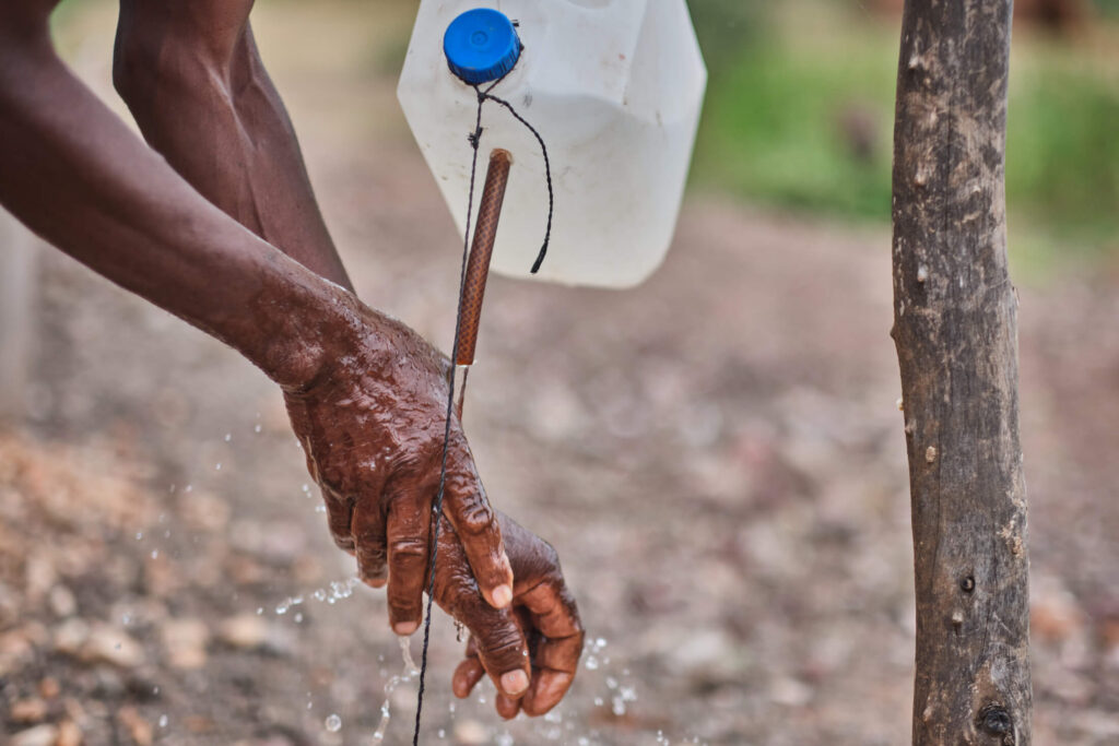 Abdel Ndou demonstrates how to use a tippy-tap in Ward 10, Beitbridge District.