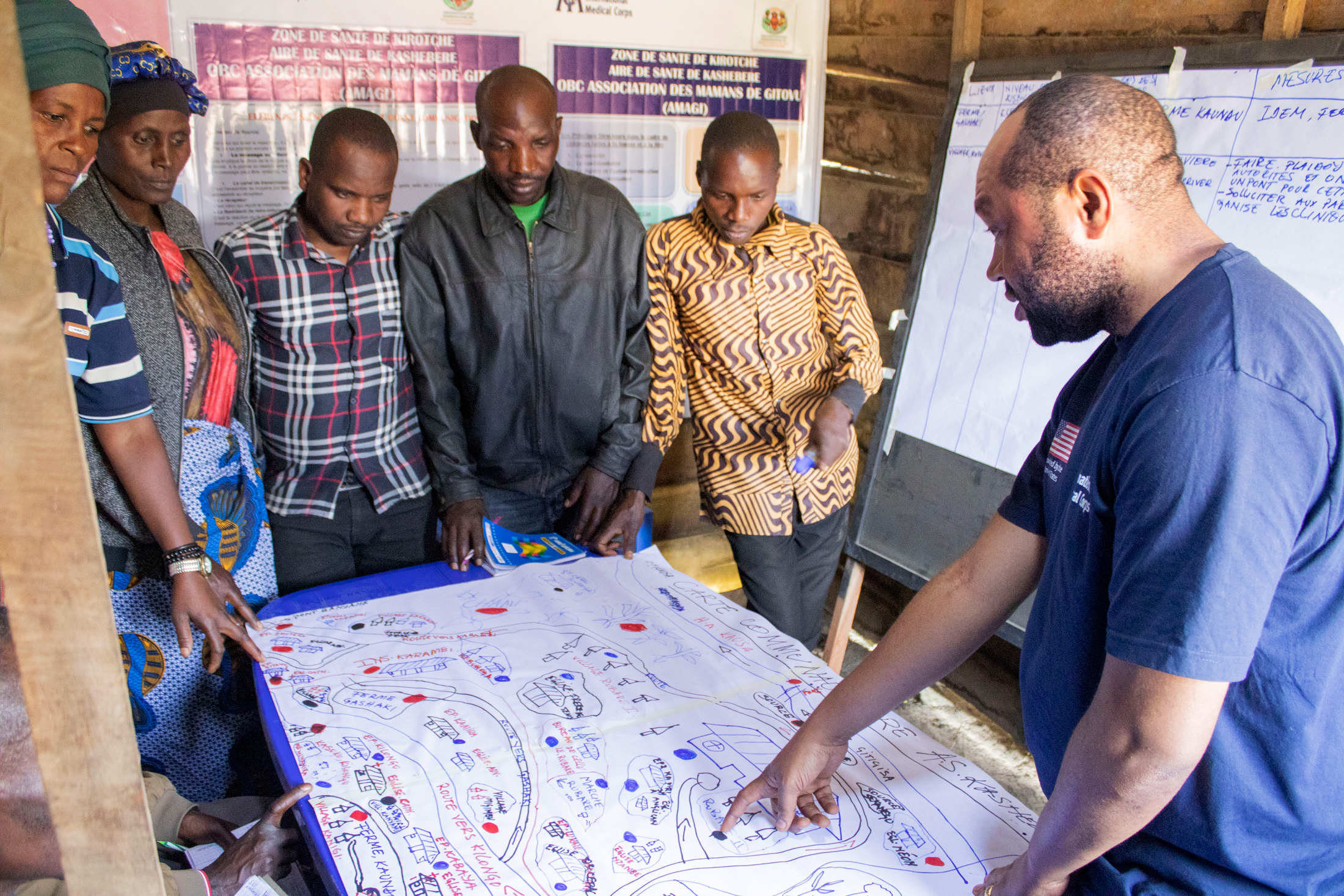 Community leaders and International Medical Corps staff map areas in the Kashebere health area where the risk of VAWG is high.