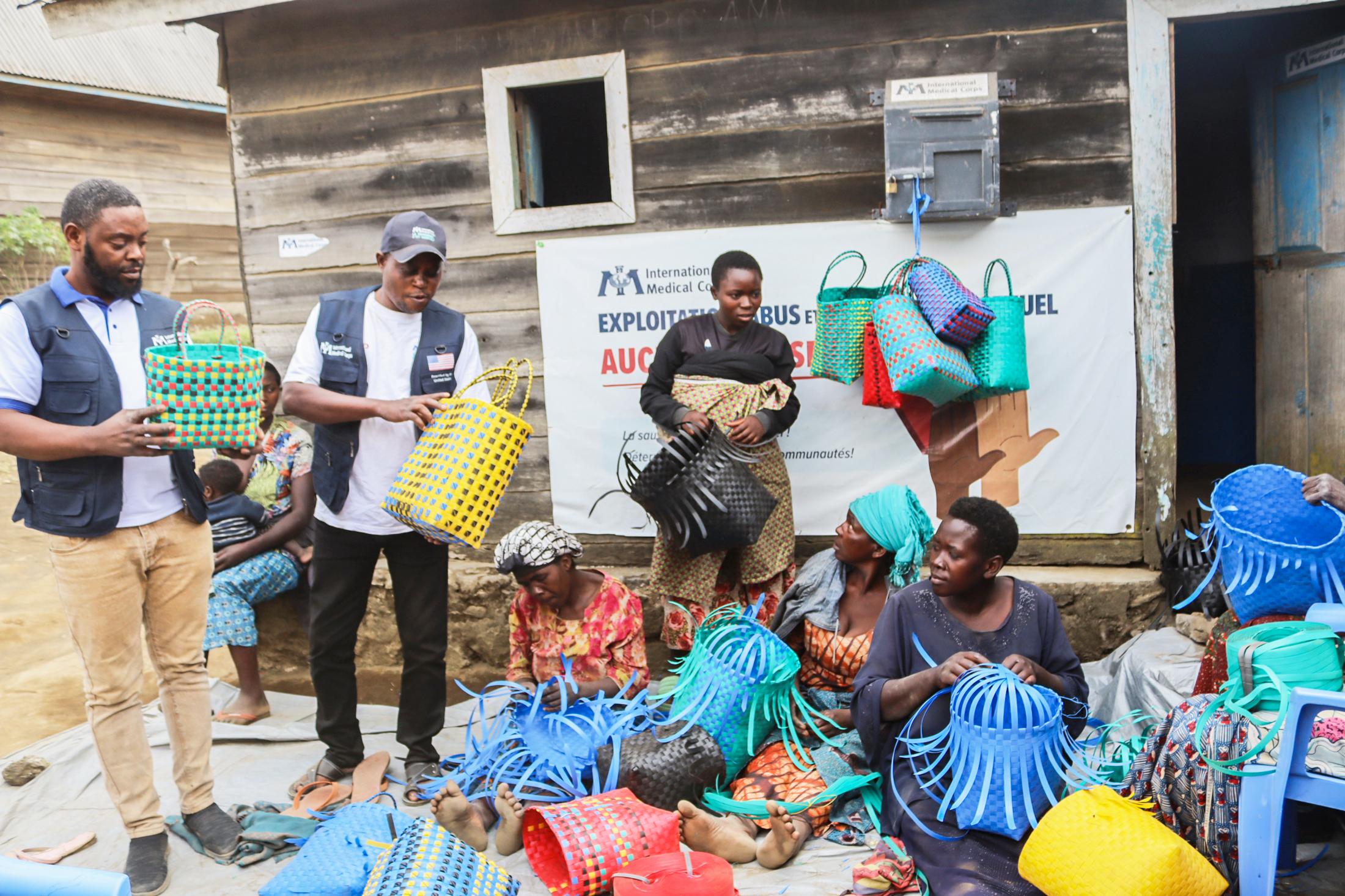 International Medical Corps staff work with women in Kashebere health area learning basket weaving.