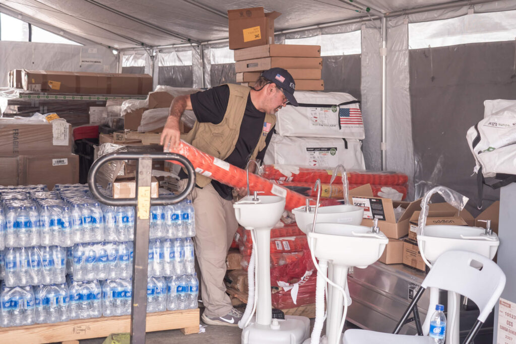 An International Medical Corps staff member organises the supplies needed to set up the EMT.